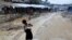 A Rohingya refugee child washes utensils in the Balukhali refugee camp in Cox's Bazar, Bangladesh, Oct. 6, 2017. 