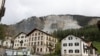 FILE - Residential buildings stand in front of the Brienzer Rutsch, the rockfall danger zone in Brienz-Brinzauls, Switzerland, May 12, 2023. 