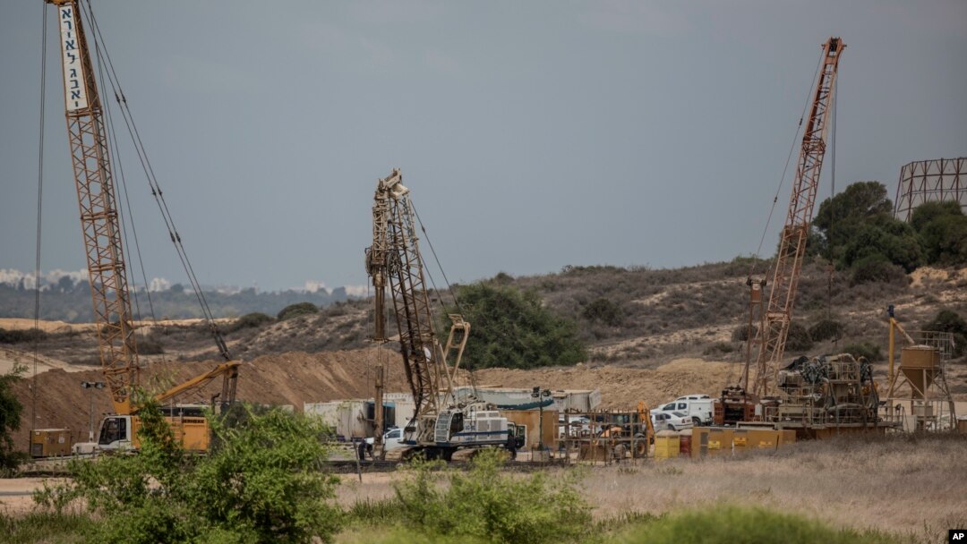 FILE - Heavy machinery is seen on the Israeli side of the border with Gaza Thursday, Sept. 8, 2016. Israel is building an underground barrier along the border with Gaza to block Hamas militants from tunneling into Israel. 