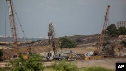 FILE - Heavy machinery is seen on the Israeli side of the border with Gaza Thursday, Sept. 8, 2016. Israel is building an underground barrier along the border with Gaza to block Hamas militants from tunneling into Israel. 