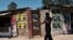 A man walks past election campaign posters for candidates in the Mabvuku-Tafara constituency on December 9, 2023. 
