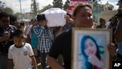 FILE - Relatives carry the coffin containing the remains of 17-year-old Siona Hernandez Garcia, a girl who died in a fire at the Virgin of the Assumption Safe Home, at the Guatemala City's cemetery, March 10, 2017.