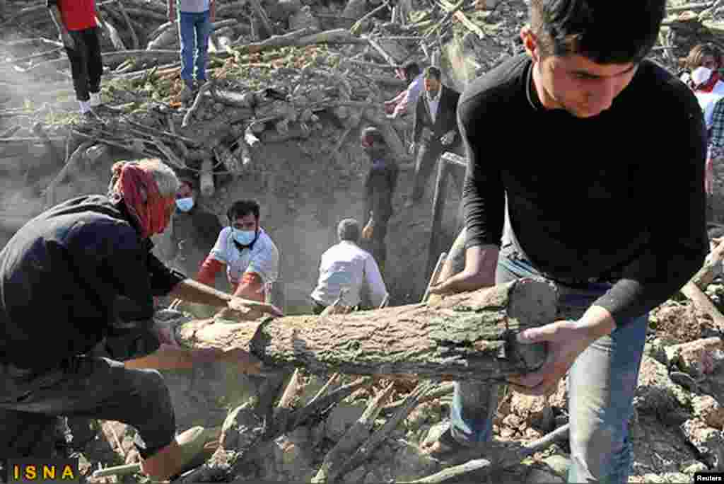 Rescue teams search for victims in Varzaqan near Ahar. Iran's government faced criticism from lawmakers and the public on its handling of relief efforts, August 12, 2012. 