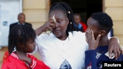 FILE - Family members of the late Agnes Wanjiru who was allegedly murdered by a British soldier in 2012, react after a court session at the Milimani Law Courts in Nairobi, Kenya, November 29, 2023.