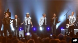 FILE - In this April 2, 2017, photo, Tyler Hubbard, from right, and Brian Kelley, third from left, of Florida Georgia Line, and from left, Nick Carter, AJ McLean, Brian Littrell, and Kevin Richardson, of Backstreet Boys, perform at the 52nd annual Academy of Country Music Awards in Las Vegas.
