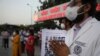 Doctors pay tribute to Indian soldiers killed during a confrontation with Chinese soldiers in the Ladakh region, while holding their photos, in New Delhi, India, June 18, 2020. 