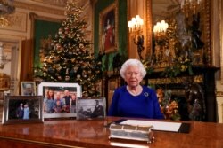 Britain's Queen Elizabeth poses, after recording her annual Christmas Day message in Windsor Castle, in Berkshire, Britain, in this undated pool picture released on Dec. 24, 2019.