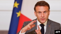 French President Emmanuel Macron gestures as he speaks next to representatives from states, international organisations, businesses, development banks and NGOs during an international humanitary conference for civilians in Gaza, at the Elysee Presidential