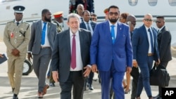 Guyanese President Irfaan Ali, right, walks with St. Vincent and the Grenadines Prime Minister Ralph Gonsalves as Ali arrives at the Argyle International Airport in Argyle, St. Vincent, on Dec. 14, 2023.