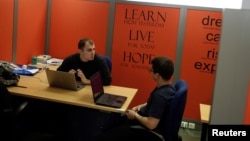 Young entrepreneurs discuss in their office, in a building offered by Eurobank's startup accelerator program EGG in Athens, Greece, February 22, 2018.