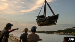 Fishermen remove their boats from the water ahead of the arrival of then-Tropical Storm Rafael in Havana on Nov. 5, 2024.