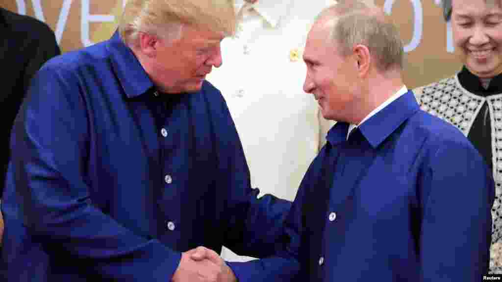 President Trump greets Russian President Vladimir Putin.