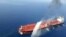 An Iranian navy boat sprays water to extinguish a fire on an oil tanker in the sea of Oman, Thursday, June 13, 2019.