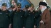FILE - In this May 20, 2015 photo, released by the office of the Iranian supreme leader, officers salute as Supreme Leader Ayatollah Ali Khamenei, right, arrives at a graduation ceremony of the Revolutionary Guard's officers in Tehran, Iran.
