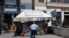 A man checks newspapers' front pages at a kiosk in Athens, June 5, 2020. 