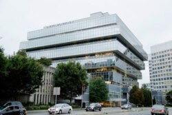 FILE - Cars pass Purdue Pharma headquarters in Stamford, Conn., Sept. 12, 2019. Local government lawsuits against the family that owns Purdue Pharma should be allowed to proceed, according to court filings this week.