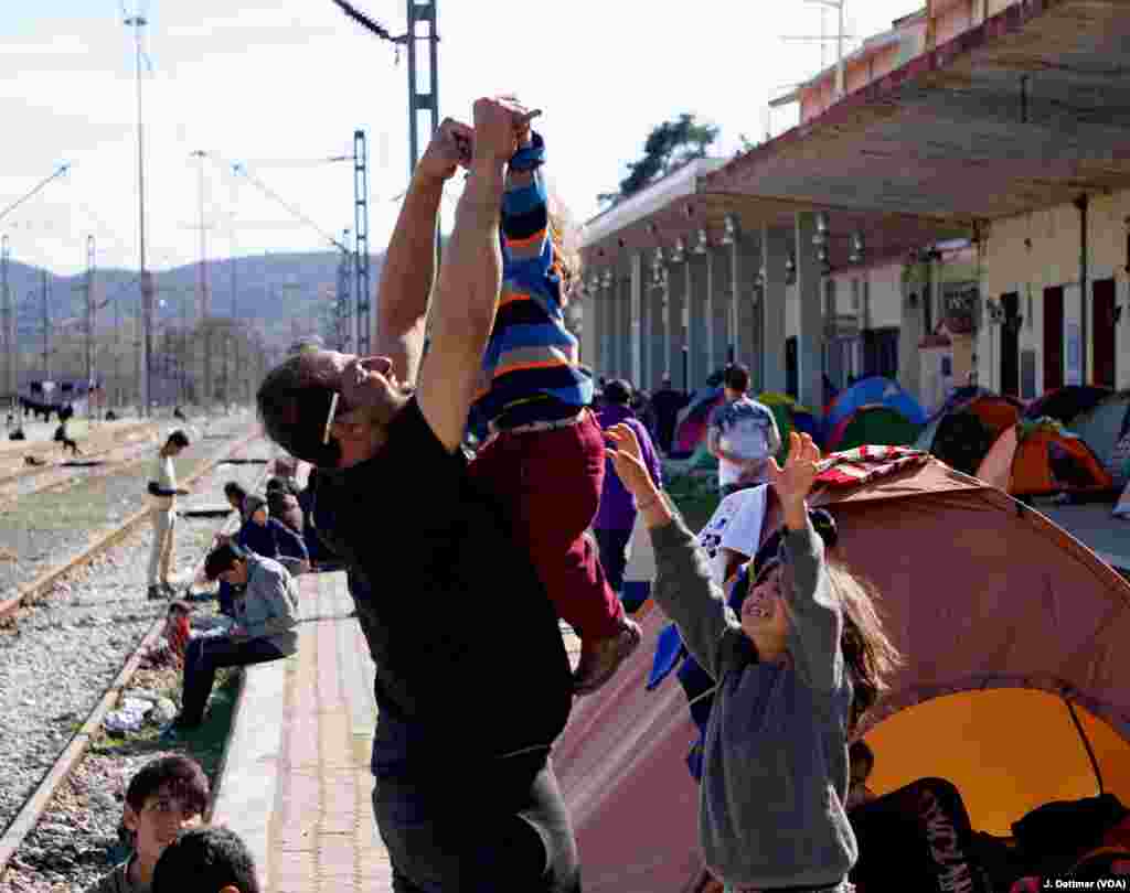 And a Syrian father plays with his son.