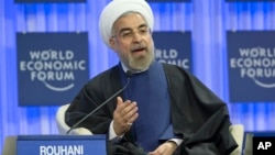 Iranian President Hassan Rouhani, gestures as speaks during a session of the World Economic Forum in Davos, Switzerland, Jan. 23, 2014.