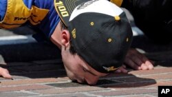 Alexander Rossi kisses the bricks on the start/finish line after wining the 100th running of the Indianapolis 500 auto race at Indianapolis Motor Speedway in Indianapolis, Sunday, May 29, 2016. 