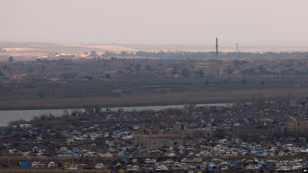 The Islamic State group's last pocket of territory in Baghouz, Syria, as seen from a distance on Sunday, March 17, 2019.