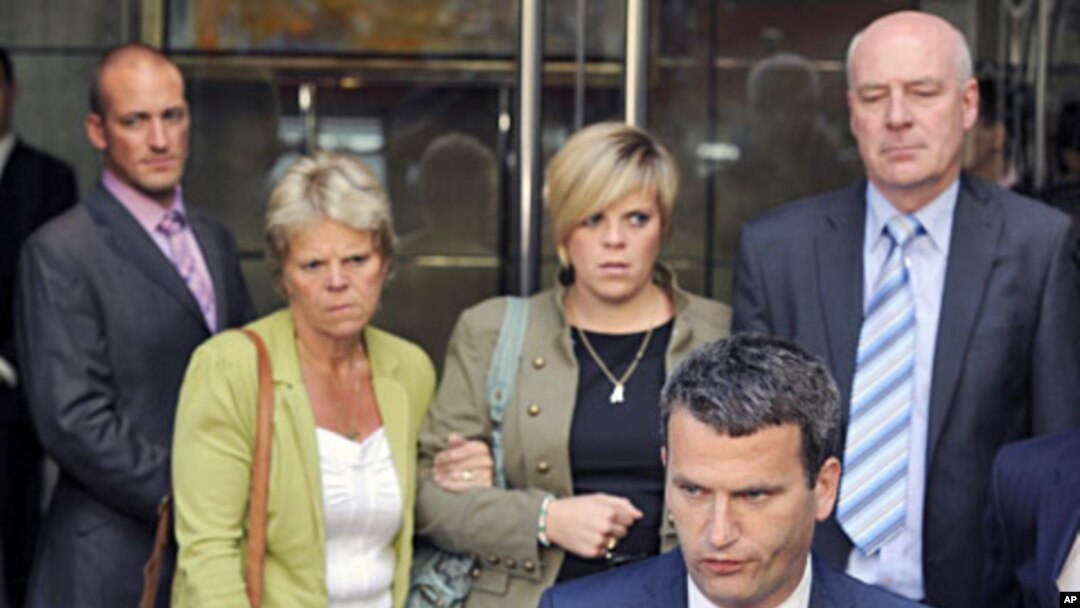 File photo shows the family of murdered teenager Milly Dowler (L-R), mother Sally Dowler, sister Gemma and father Bob standing behind their lawyer Mark Lewis after meeting Rupert Murdoch at a hotel in central London, July 15, 2011