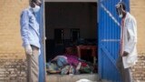 Workers open the doors of a morgue in South Sudan last year revealing the bodies of victims of the conflict that a leaked African Union report calls "intense and brutal." 