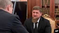 Russian President Vladimir Putin, left, meets with Chechnya's regional leader Ramzan Kadyrov in the Kremlin in Moscow, Russia, April 19, 2017.