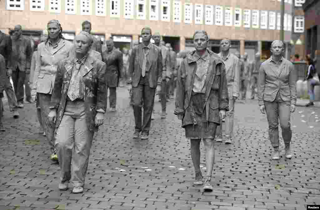 Participants perform during the so called &quot;1000 Figures&quot; demonstration before the upcoming G20 summit in Hamburg, Germany.