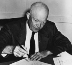 President Dwight D. Eisenhower signs the Civil Rights Act of 1957 at a naval base in Newport, Rhode Island, Sept. 9, 1957. (Courtesy - U.S. National Archives)