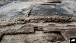 This undated photo released by the Egyptian Ministry of Antiquities, shows an ancient workshop to build and repair ships, dating back to the Ptolemaic era in the country's Sinai Peninsula, Egypt. 