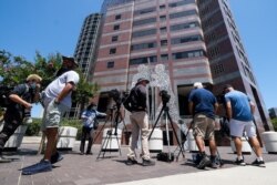 Members of the media wait outside federal court building after Thomas Barrack, a billionaire friend of Donald Trump who chaired the former president's inaugural fund, is arrested, in Los Angeles, California, July 20, 2021.