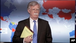 FILE - Then-national security adviser John Bolton listens during a press briefing at the White House, Jan. 28, 2019, in Washington.