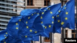 European Union flags fly outside the European Commission headquarters in Brussels, Belgium, March 6, 2019.