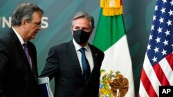 Secretary of State Antony Blinken, right, departs with Mexico's Foreign Minister Marcelo Ebrard after a joint news conference at the Mexican Ministry of Foreign Affairs, in Mexico City, Oct. 8, 2021.