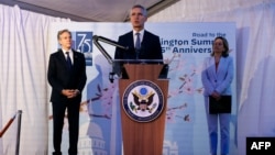 NATO Secretary General Jens Stoltenberg delivers a speech flanked by U.S. Secretary of State Antony Blinken and US. Ambassador to NATO Julianne Smith at a ceremony marking the 75th anniversary of the NATO alliance in Brussels.