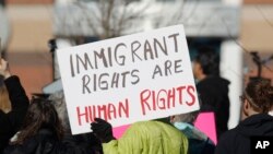 A supporter holds up a placard during a rally for Jeanette Vizguerra, a Mexican woman seeking to avoid deportation from the United States, outside the Immigration and Customs Enforcement office in Centennial, Colo., Feb. 15, 2017. U.S. immigration authorities have denied Vizguerra's request to remain in the country.