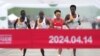 Chinese runner He Jie, second from right, Ethiopian Dejene Hailu Bikila and Kenyans Robert Keter and Willy Mnangat take part in a half-marathon in Beijing, China, April 14, 2024. (cnsphoto via REUTERS) 