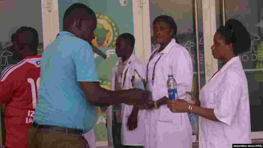 Fans and officials clean thier hands before entering stadium effort to prevent spreed of ebola.