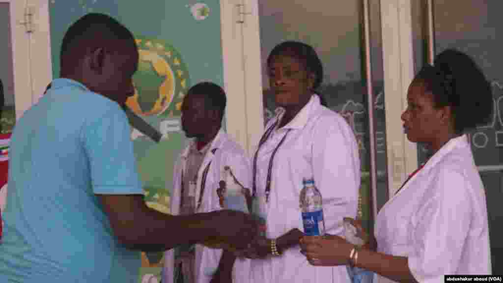 Fans and officials clean thier hands before entering stadium effort to prevent spreed of ebola.