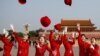 Ushers throw their hats in the air as they pose for photographers at the Tiananmen Square before the start of the closing session of the 19th National Congress of the Communist Party of China, in Beijing, China October 24, 2017.