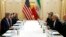 FILE - US Secretary of State John Kerry (L) meets with Iranian Foreign Minister Javad Zarif (2R) in Vienna, Austria on Jan. 16, 2016, on what is expected to be "implementation day," the day the IAEA verifies that Iran has met all conditions under the nuclear d