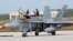 FILE - An Australian fighter jet is readied for a training mission at Andersen Air Force Base on the U.S. island of Guam, Feb. 7, 2013. Australia announced Friday that it would recall its fighter jets from Iraq and Syria.