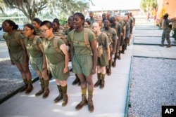 A group of female U.S. Marine Corps recruits stand in platoon order outside the Marine Corps Recruit Depot pool after swim training, Wednesday, June 28, 2023, in Parris Island, S.C. (AP Photo/Stephen B. Morton)