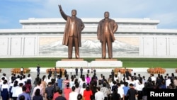 FILE - People visit the the statues of North Korea's founder Kim Il Sung and late leader Kim Jong Il on the 74th anniversary of North Korea's founding, in Pyongyang, North Korea on September 10, 2022. (KCNA via REUTERS)