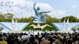 Doves fly near the Peace Statue in Nagasaki&#39;s Peace Park during a ceremony commemorating the 68th anniversary of the atomic bombing of the city, August 9, 2013. (Reuters/Kyodo) 