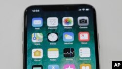 The new iPhone X is displayed in the showroom after the new product announcement at the Steve Jobs Theater on the new Apple campus on Sept. 12, 2017, in Cupertino, Calif.