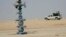 An Iraqi army vehicle secures the Akkas gas field in the western desert of Iraq, Oct. 19, 2010.