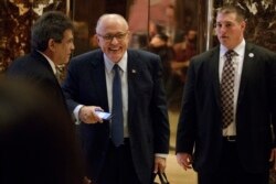 FILE - Rudy Giuliani, center, leaves Trump Tower, Nov. 11, 2016, in New York.