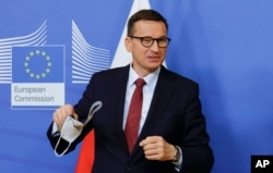 FILE - Poland's Prime Minister Mateusz Morawiecki arrives for a meeting with European Commission President Ursula von der Leyen at EU headquarters in Brussels, Belgium, July 13, 2021.