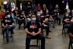 Employees wait to hear President Donald Trump speak after a tour of a Honeywell International plant that manufactures personal protective equipment, in Phoenix, May 5, 2020.